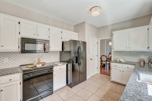 kitchen with white cabinetry and black appliances