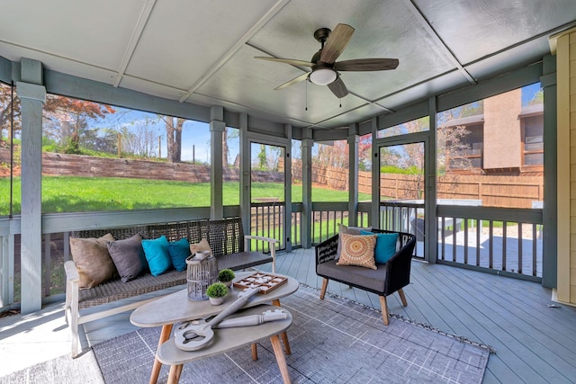 sunroom / solarium featuring an outdoor living space and ceiling fan