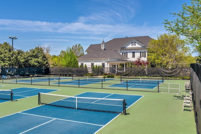view of tennis court featuring fence and community basketball court