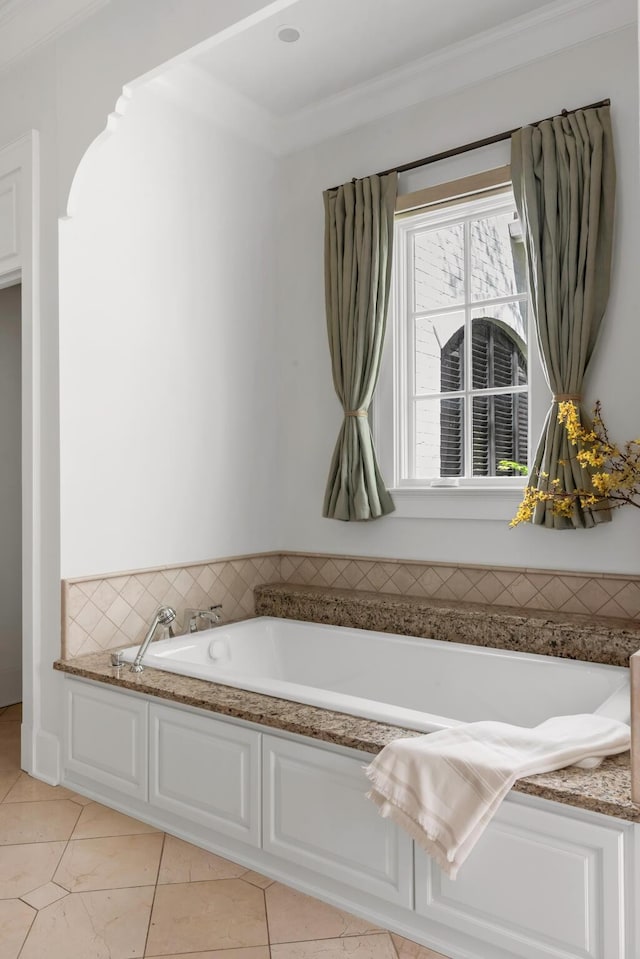 bathroom featuring tile patterned floors and a bath