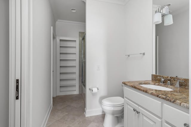 bathroom with vanity, ornamental molding, toilet, enclosed tub / shower combo, and baseboards