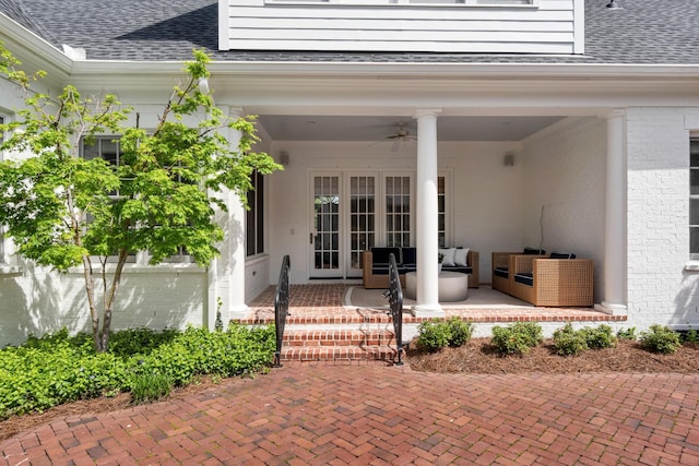 exterior space featuring a patio, french doors, a shingled roof, and brick siding