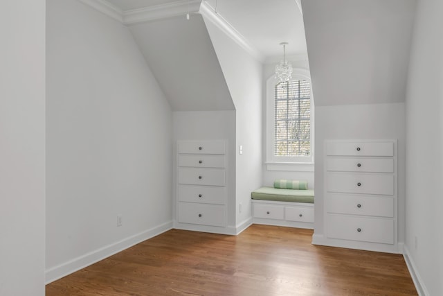 additional living space featuring baseboards, vaulted ceiling, and wood finished floors