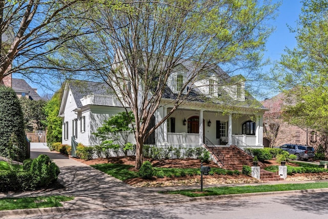 view of front facade with a porch and stucco siding