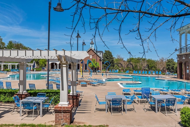 pool with a pergola and a patio area