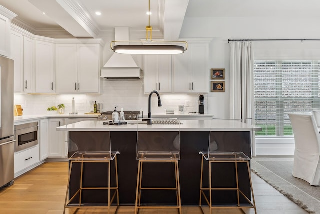 1060 Veridian Dr Unit 23A, Clarksville, TN 37043 - kitchen featuring light wood-type flooring, stainless steel microwave, light countertops, and a breakfast bar area