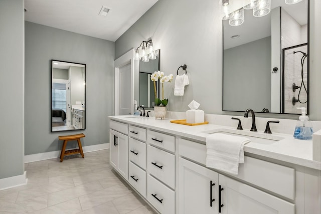 1060 Veridian Dr Unit 23A, Clarksville, TN 37043 - bathroom with double vanity, a tile shower, baseboards, and a sink