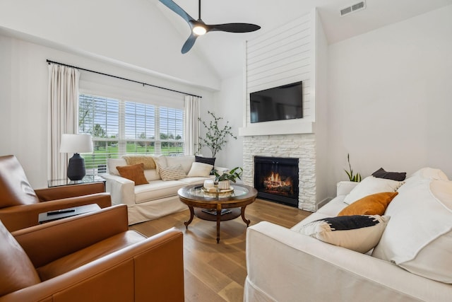 1060 Veridian Dr Unit 23A, Clarksville, TN 37043 - living room featuring lofted ceiling, a stone fireplace, visible vents, ceiling fan, and wood finished floors