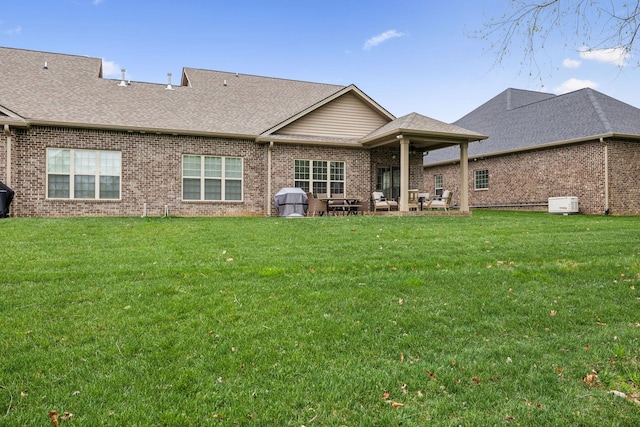 1060 Veridian Dr Unit 23A, Clarksville, TN 37043 - rear view of house featuring brick siding, a yard, a patio, and roof with shingles