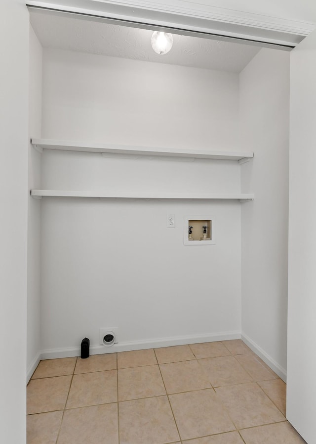 laundry area featuring baseboards, washer hookup, laundry area, electric dryer hookup, and tile patterned flooring