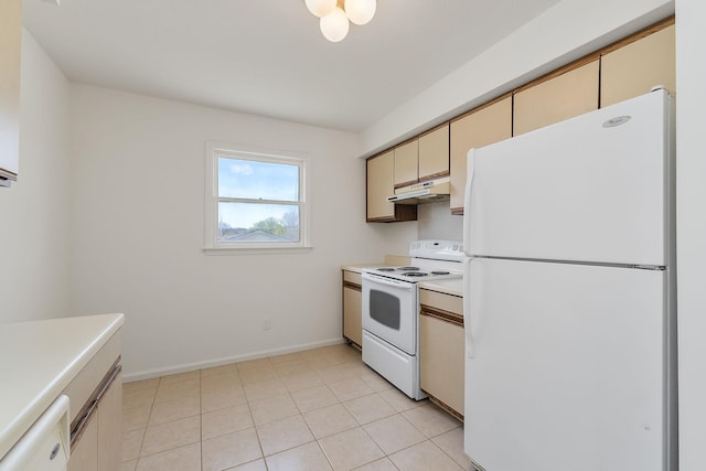kitchen with under cabinet range hood, light countertops, white appliances, and cream cabinetry