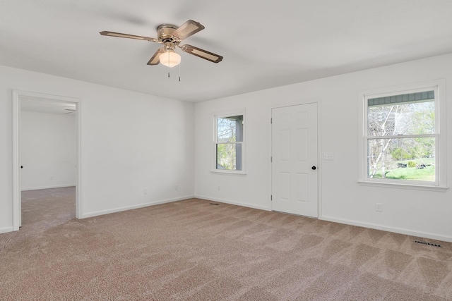 unfurnished room with carpet floors, ceiling fan, and baseboards