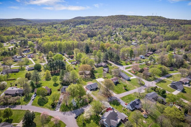 bird's eye view featuring a wooded view and a residential view