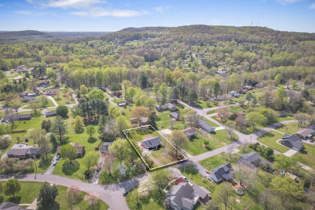 drone / aerial view featuring a view of trees and a residential view