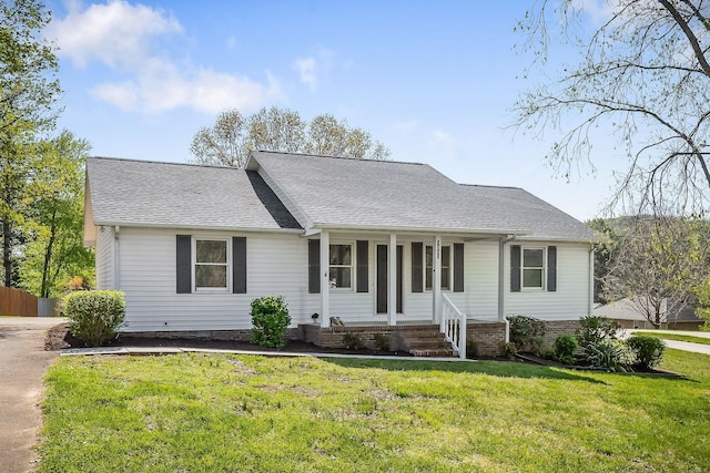 ranch-style home with a front yard, a porch, a shingled roof, and concrete driveway