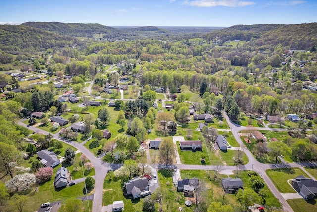 drone / aerial view featuring a forest view, a mountain view, and a residential view
