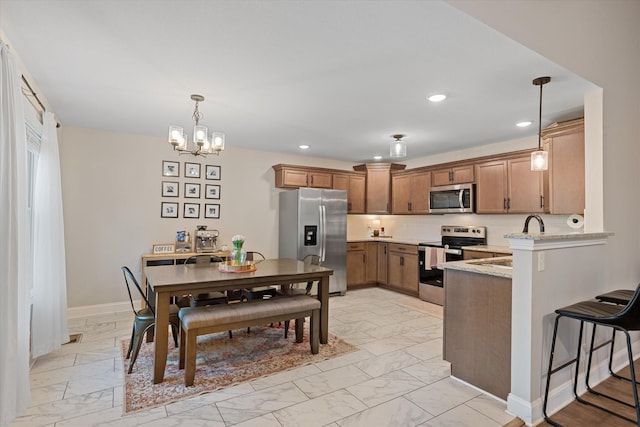 2229 Allen Griffey Rd, Clarksville, TN 37042 - kitchen with stainless steel appliances, recessed lighting, marble finish floor, and a peninsula