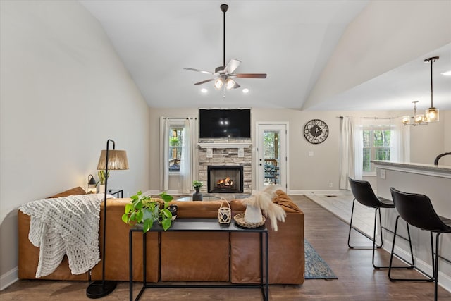 2229 Allen Griffey Rd, Clarksville, TN 37042 - living room featuring wood finished floors, a stone fireplace, baseboards, ceiling fan with notable chandelier, and vaulted ceiling