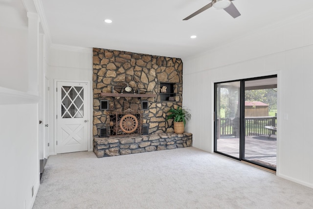unfurnished living room with ornamental molding, recessed lighting, a fireplace, ceiling fan, and carpet