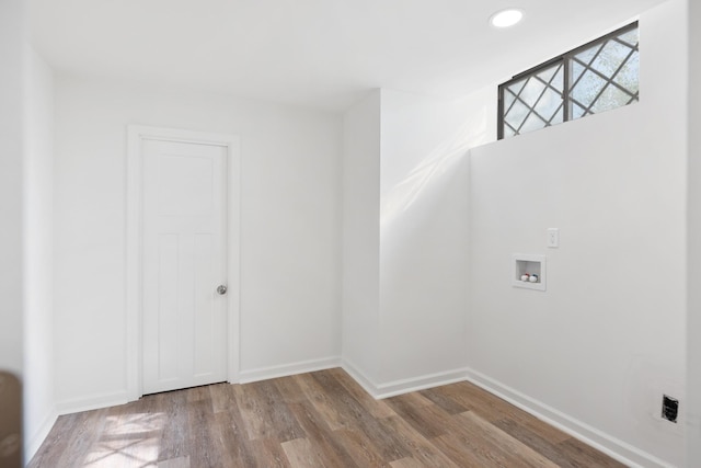 interior space featuring recessed lighting, baseboards, and wood finished floors
