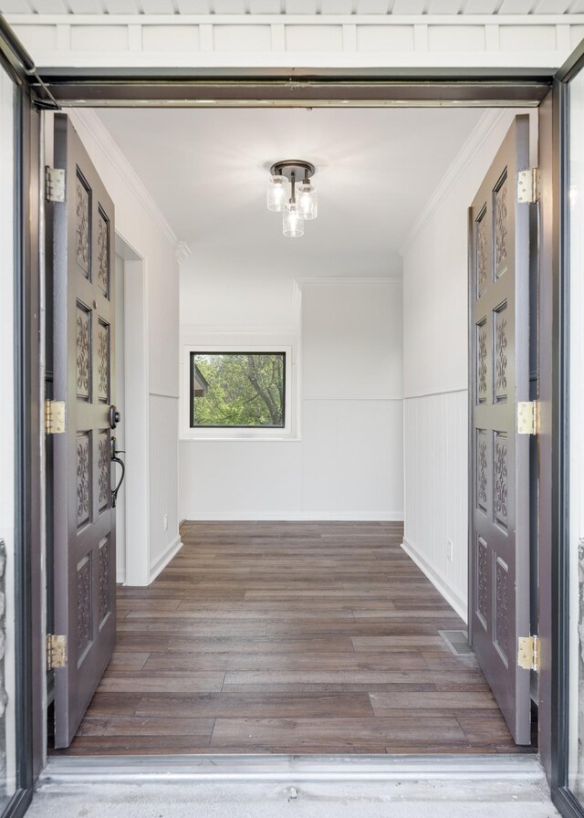 hall featuring ornamental molding and wood finished floors