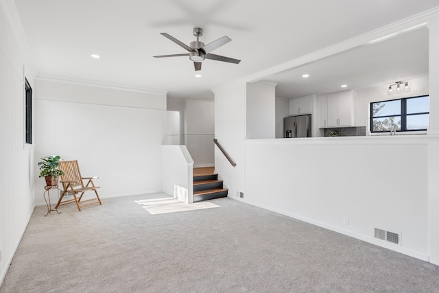 unfurnished living room featuring recessed lighting, a ceiling fan, visible vents, and carpet floors