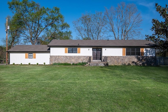 ranch-style house with a front yard and stone siding