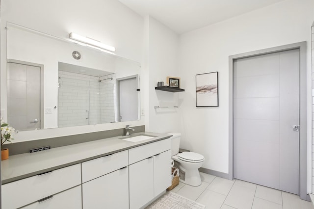 full bathroom with tile patterned flooring, vanity, a tile shower, and toilet