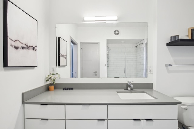 full bath with toilet, a shower stall, and vanity