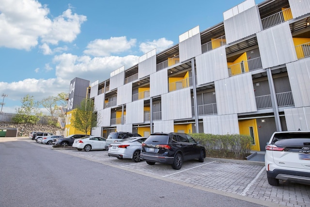 view of building exterior with uncovered parking