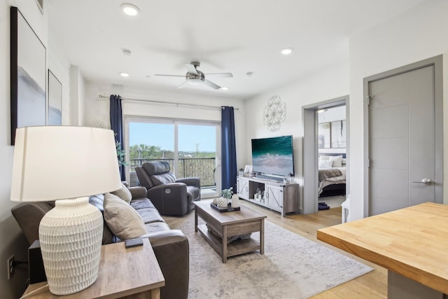 living area featuring recessed lighting, light wood-style floors, and a ceiling fan