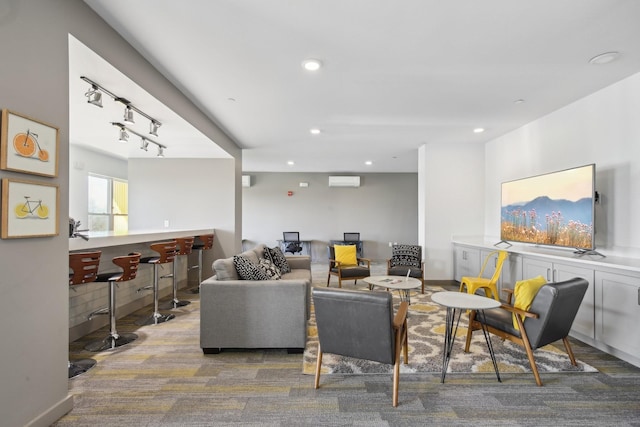 living area with rail lighting, a wall unit AC, recessed lighting, a bar, and carpet floors