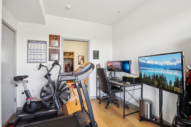 exercise room with wood finished floors