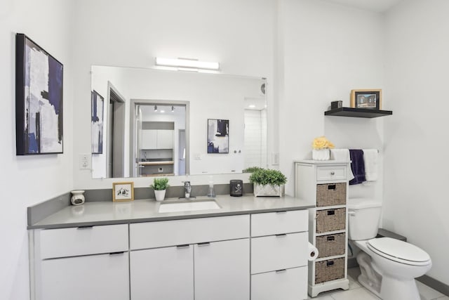 bathroom with tile patterned flooring, toilet, and vanity