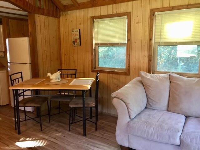 5735 Railroad St, Williston, TN 38076 - dining room featuring healthy amount of natural light, wood walls, and wood finished floors
