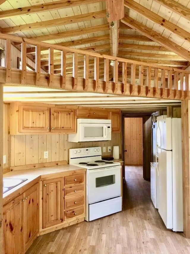 5735 Railroad St, Williston, TN 38076 - kitchen with white appliances, wooden ceiling, light wood finished floors, light countertops, and wooden walls