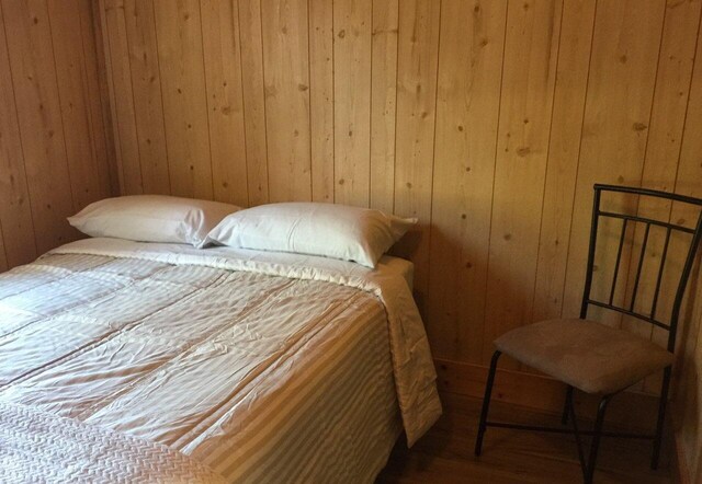 5735 Railroad St, Williston, TN 38076 - bedroom with wood walls and wood finished floors