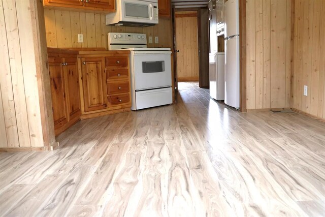 5735 Railroad St, Williston, TN 38076 - kitchen with white appliances, wooden walls, light wood-type flooring, and brown cabinets