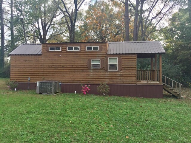 5735 Railroad St, Williston, TN 38076 - view of side of property with central air condition unit, a yard, metal roof, view of scattered trees, and stairway