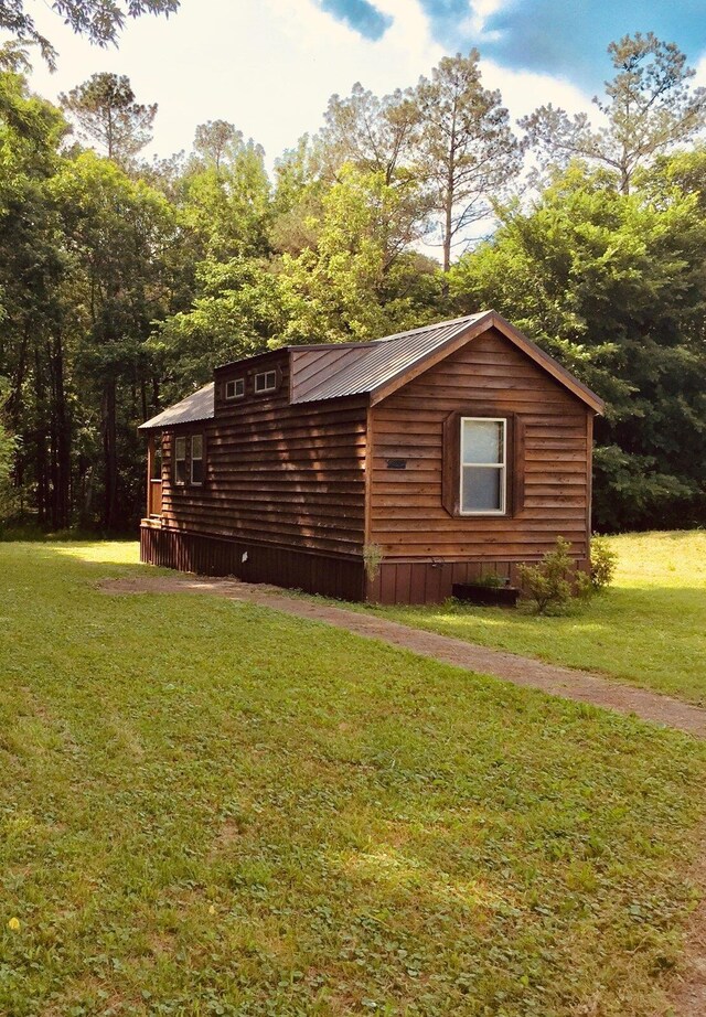 5735 Railroad St, Williston, TN 38076 - view of home's exterior with a yard and metal roof