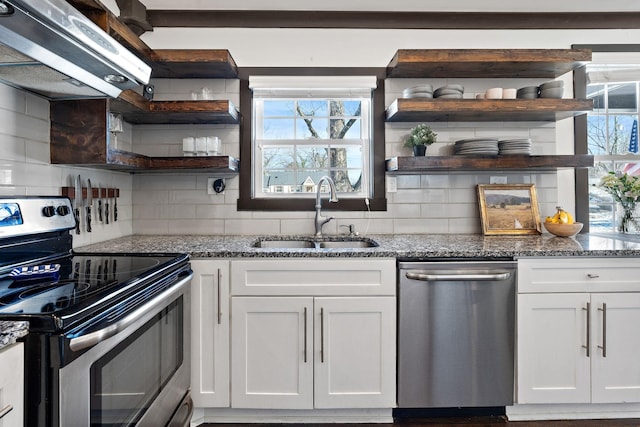 kitchen with white cabinetry, exhaust hood, open shelves, appliances with stainless steel finishes, and a sink