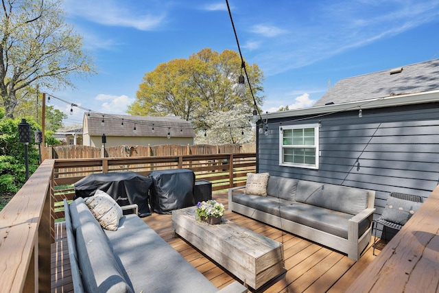 wooden terrace featuring fence and an outdoor hangout area