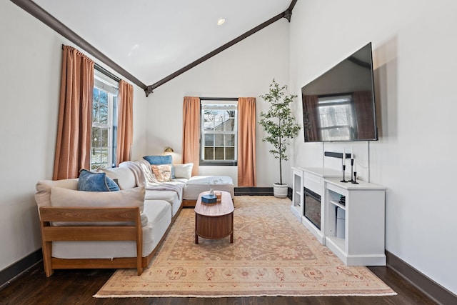 living room featuring dark wood-type flooring, baseboards, and vaulted ceiling