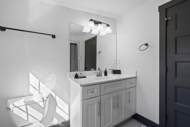bathroom with a shower with shower curtain, vanity, and baseboards