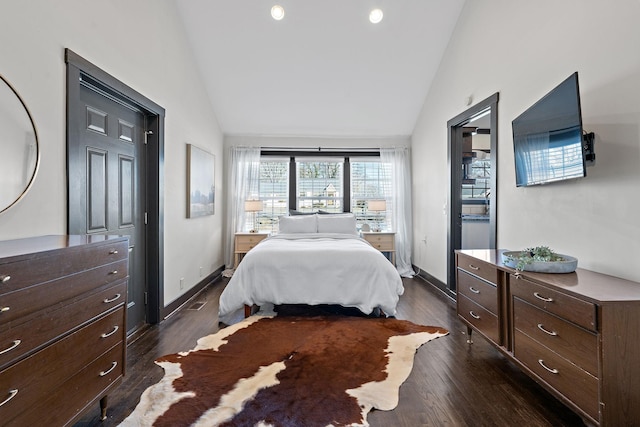 bedroom featuring high vaulted ceiling, dark wood-type flooring, and baseboards