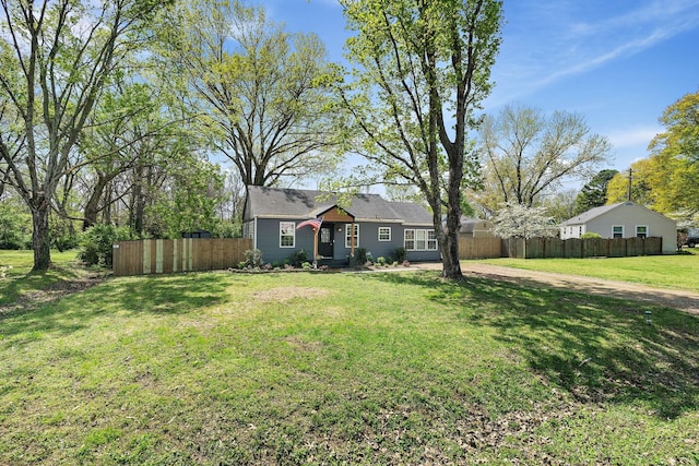 single story home featuring a front yard and fence