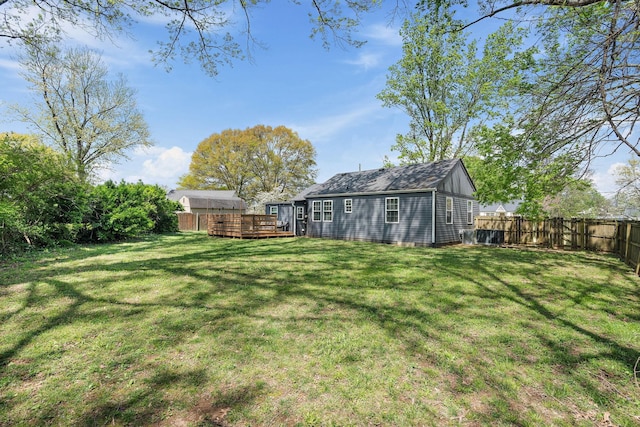 view of yard with a fenced backyard and a deck