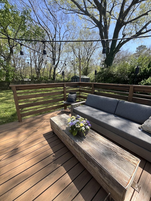 deck featuring an outdoor living space and an outdoor structure