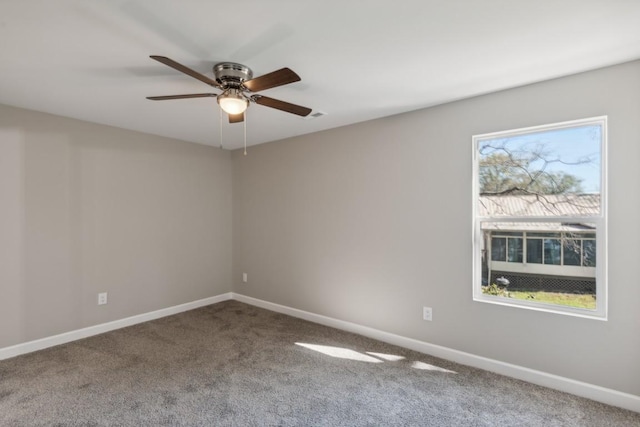 unfurnished room featuring baseboards, a ceiling fan, and carpet