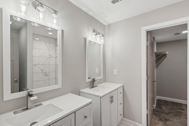 bathroom with two vanities, a sink, and baseboards